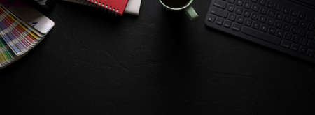 Overhead shot of stylish designer worktable with tablet, notebooks, designer supplies and copy spaceの写真素材