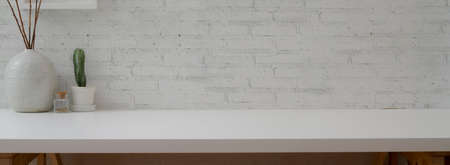 Close up view of home office desk with stationery, mock-up laptop, books and copy space の写真素材