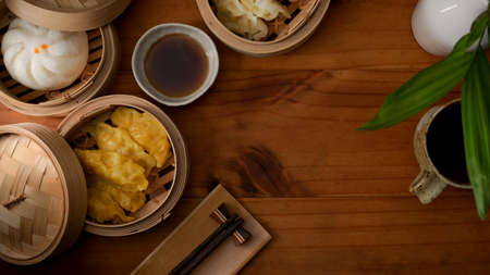 Top view of steamed dumplings serving on bamboo seamer on wooden table with copy space in Chinese restaurantsの写真素材