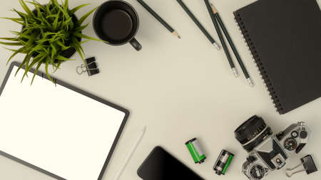 Top view of mock up scene creator with mock up tablet, camera, stationery, smartphone, decoration and copy space on tableの写真素材