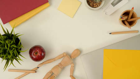 Top view of mock up scene creator with laptop, stationery, notebooks, decorations and copy space on...
