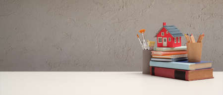 Close up view of workspace with school elements and copy space on white table in living room