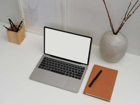 Overhead shot of blank screen laptop on worktable  stationery and decorations,  .の写真素材