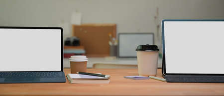 Close up view of blank screen tablets  keyboard on wooden table in office room,  .