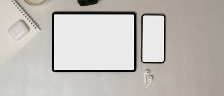 Top view of digital tablet and smartphone  accessories on white table,  .