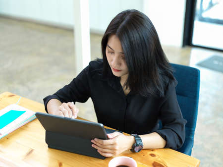 Cropped shot of female college student preparing her presentation on digital tabletの写真素材