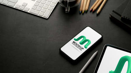 Cropped shot of workplace with mock up smartphone, tablet, supplies, accessories and copy space on...