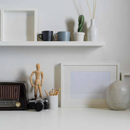 Close up view of worktable with camera, vintage radio, decorations and copy space in living roomの写真素材