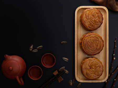 Top view of table setting with traditional moon cakes, tea set and copy space in moon festival....