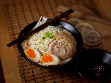 Close up view of Tonkotsu ramen, traditional Japan noodle with sliced pork and eggs and pork bone...