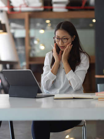 Young businesswoman getting exited about the work project in office room