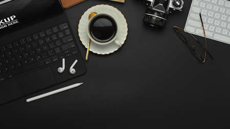 Top view of workspace with coffee cup, stylus, tablet, keyboard, camera and copy spaceの写真素材