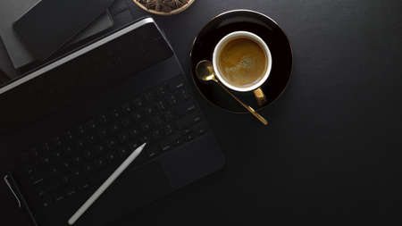 Top view of workspace with coffee cup, digital tablet, stylus, keyboard and copy spaceの写真素材