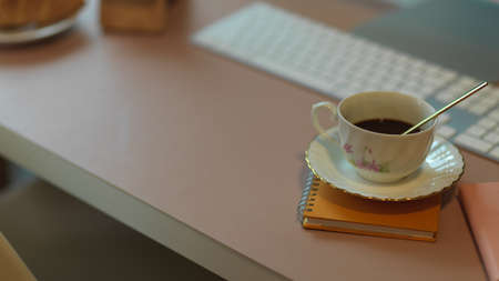Close up view of coffee cup on computer table with copy space and supplies