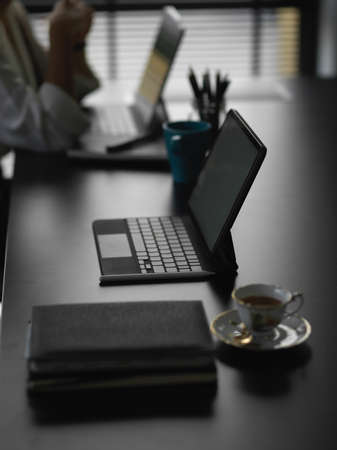 Close up view of modern workspace with tablet and office supplies on the tableの写真素材