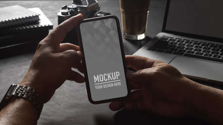 Close up view of male hand holding smartphone screen