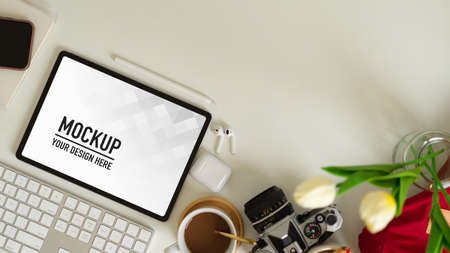 Top view of workspace with tablet, computer keyboard, camera, supplies and copy spaceの写真素材