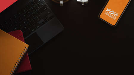 Top view of workspace with smartphone, notebooks, keyboard and copy space