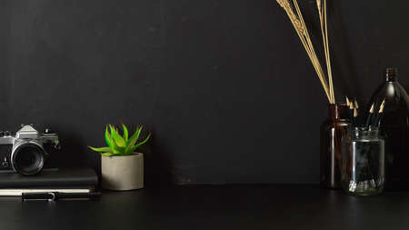 Close up view of home office desk with copy space, camera, stationery and copy spaceの写真素材