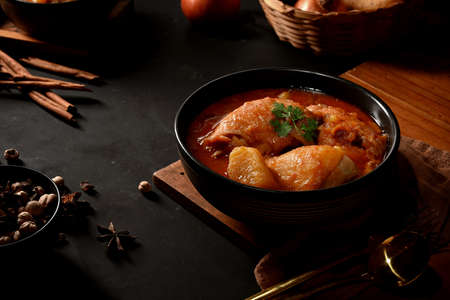 Close up view of chicken Massaman Curry soup with ingredients on kitchen table, Thai traditional...