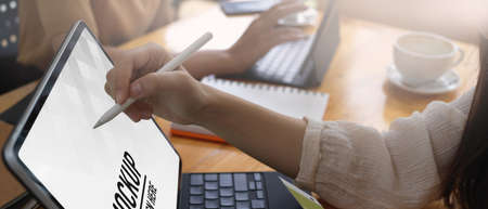 Side view of female using digital tablet white stylus pen