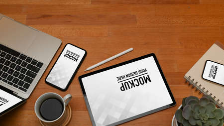Top view of digital devices, notebook, coffee cup and copy spaceの写真素材