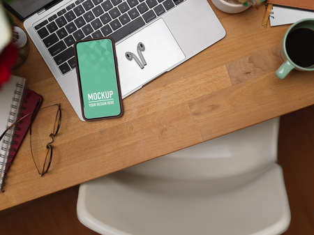 Top view of workspace  smartphone, laptop, supplies and accessories on the table,の写真素材