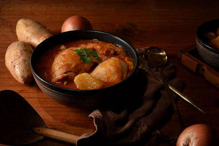 Close up view of Thai traditional food, chicken Massaman Curry soup on wooden kitchen tableの写真素材