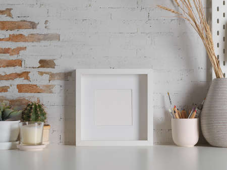 Close up view of worktable with decorations and copy space in loft home office roomの写真素材
