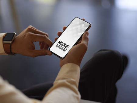 Close up view of businessman hands using smartphone while relaxed sitting in office room, clipping...