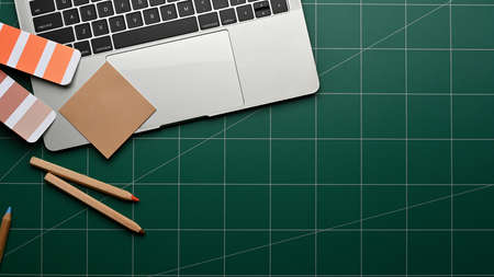 Top view of workspace with laptop, stationery and copy space eon cutting board