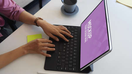 Cropped shot of hands typing on tablet keyboard on meeting table in office room, clipping path