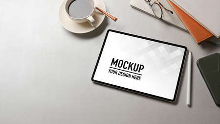 Top view of white worktable with tablet, stationery, coffee cup and copy space, include clipping...