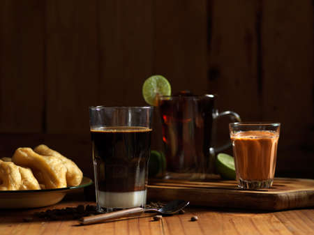 Close up view of Thai style breakfast with lemon tea, coffee, Thai milk tea and deep fried dough...