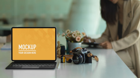 Close up view of portable workspace with tablet, camera and accessories on the tableの写真素材