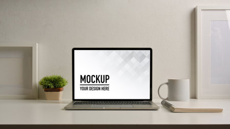 Close up view of home office desk  laptop, stationery and decorations,