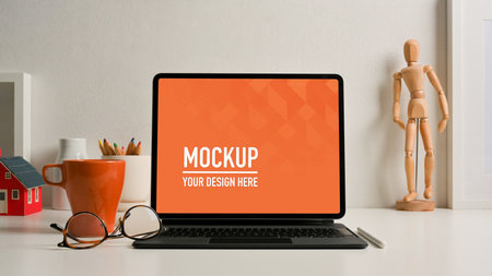 Close up view of worktable  tablet, eyeglasses, decorations in home office,の写真素材