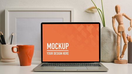 Close up view of worktable  laptop, stationery and decorations in home officeの写真素材