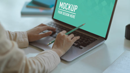 Close up view of businesswoman hands typing on laptop on meeting tableの写真素材