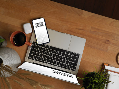 Top view of workspace with laptop, smartphone, supplies and decorationsの写真素材