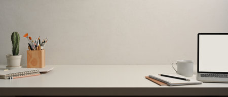 Close up view of worktable with laptop, notebooks, stationery and copy space in home office roomの写真素材