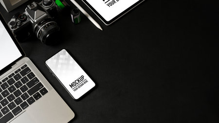 Top view of workspace with smartphone, laptop, tablet, camera and copy space, clipping path