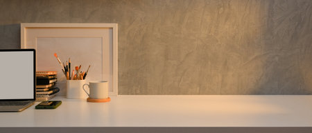 Close up view of worktable with laptop, stationery and decoration in home office room