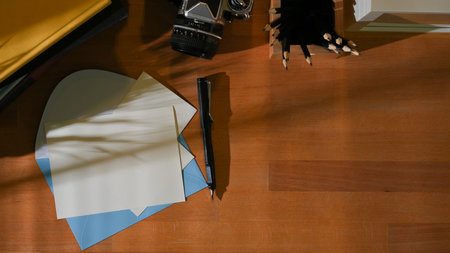 Top view of workspace with mock up card , envelope, stationery and copy space in home office room