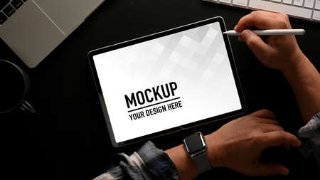 Top view of male hand using digital tablet include clipping path on black table