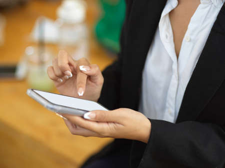 Side view of businesswoman using smartphone include  office room