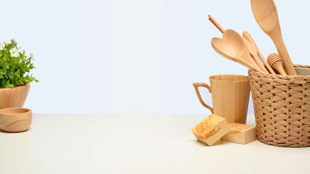 Close up view of creative mock up scene with wooden kitchenware and copy space on white background,...