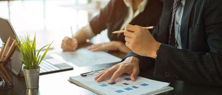 Cropped shot of two businesspeople working on business paperwork together in meeting room