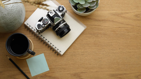 Mock up scene, creative flat lay workspace with camera, stationery, coffee cup, decorations and copy space, top viewの写真素材