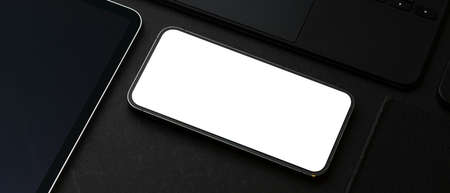 Cropped shot of smartphone with mock up screen on black table, clipping path